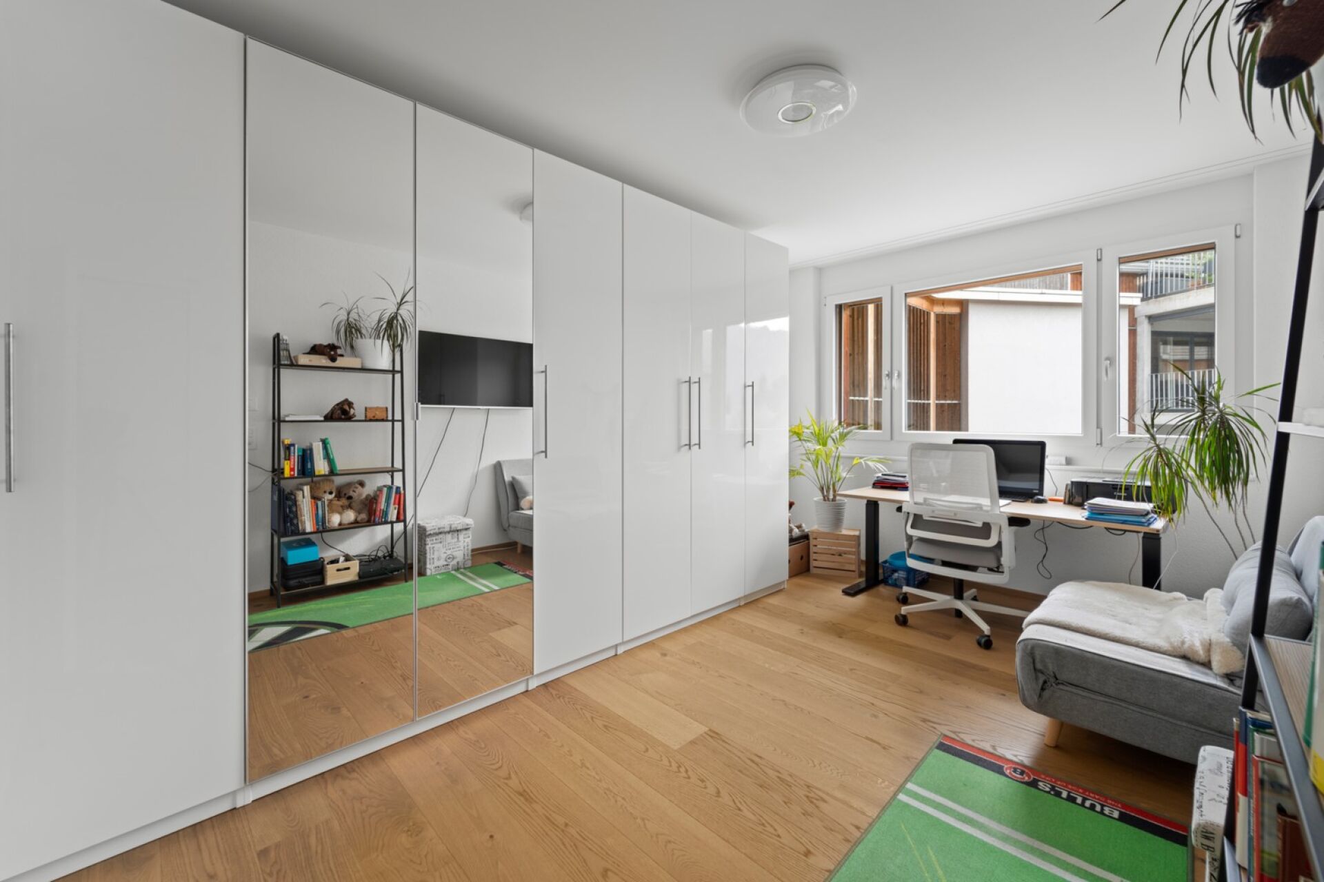 Helles Arbeitszimmer mit Einbauschrank und Fensterfront