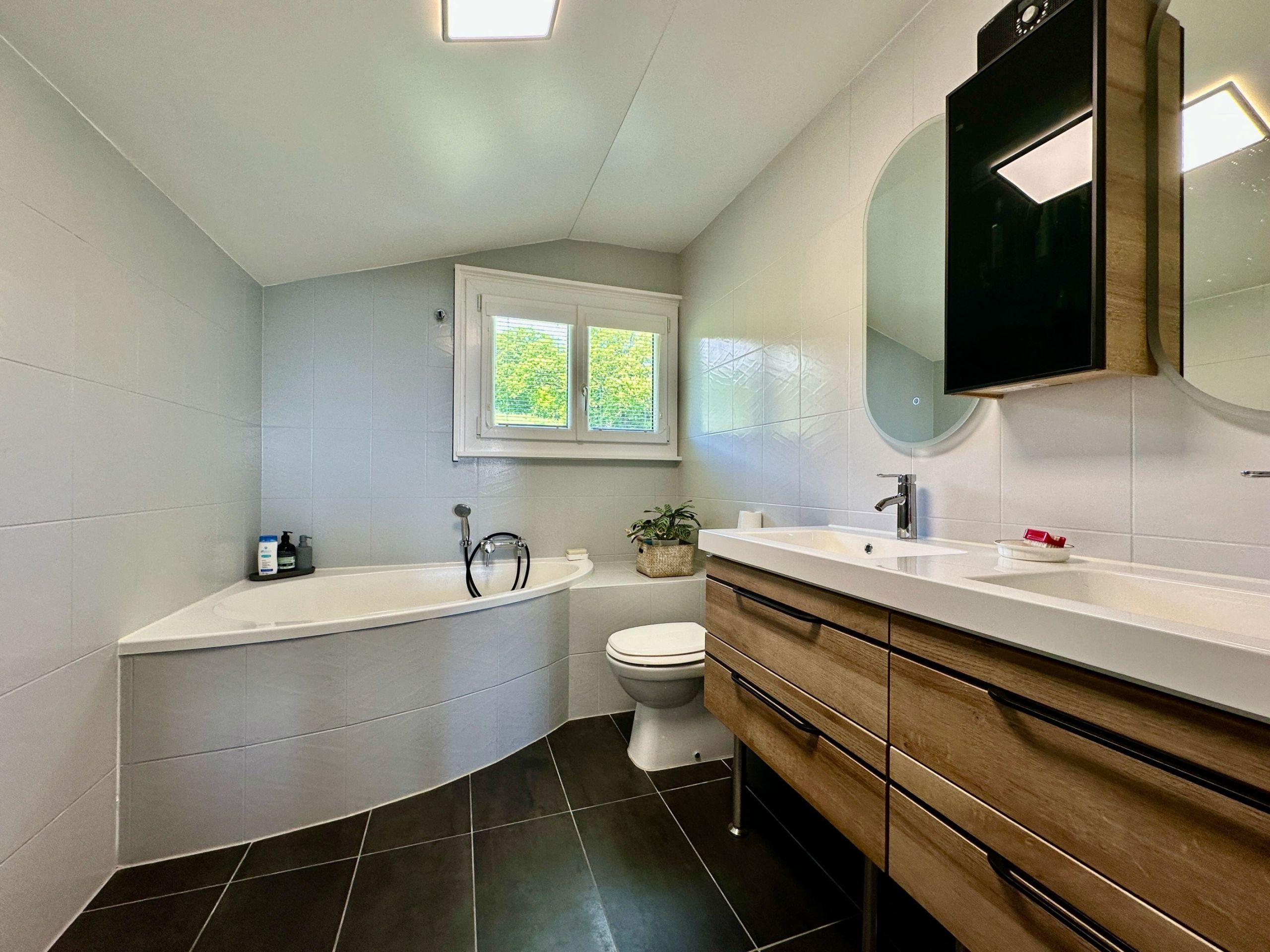 Modernes Badezimmer mit Badewanne und Doppelwaschtisch