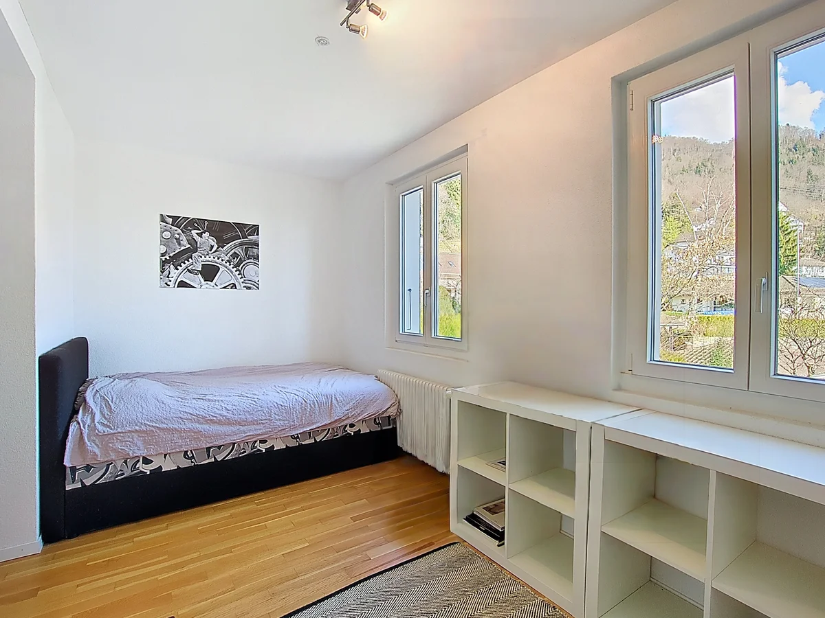 Helles Schlafzimmer mit zwei Fenstern und Stauraum