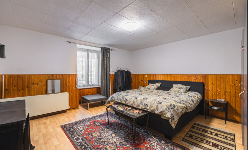 Schlafzimmer mit Holzvertäfelung und Teppichen