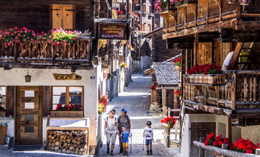 Alpendorfstraße mit Café und traditionellen Holzchalets