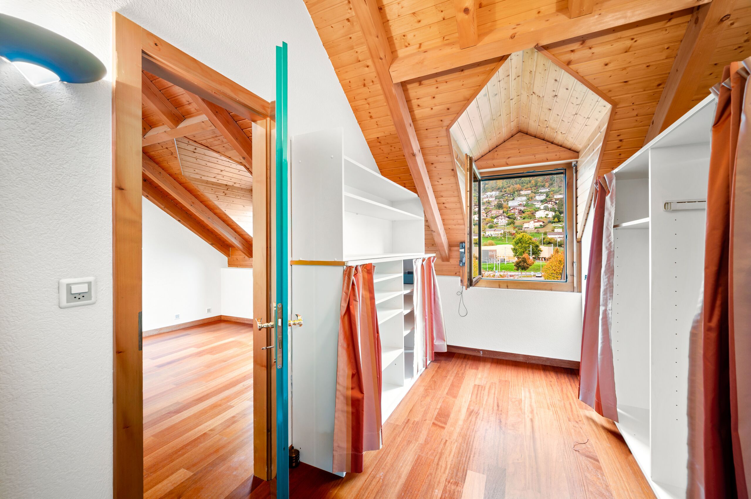 Dachgeschoss-Ankleide mit Holzdecken und Ausblick