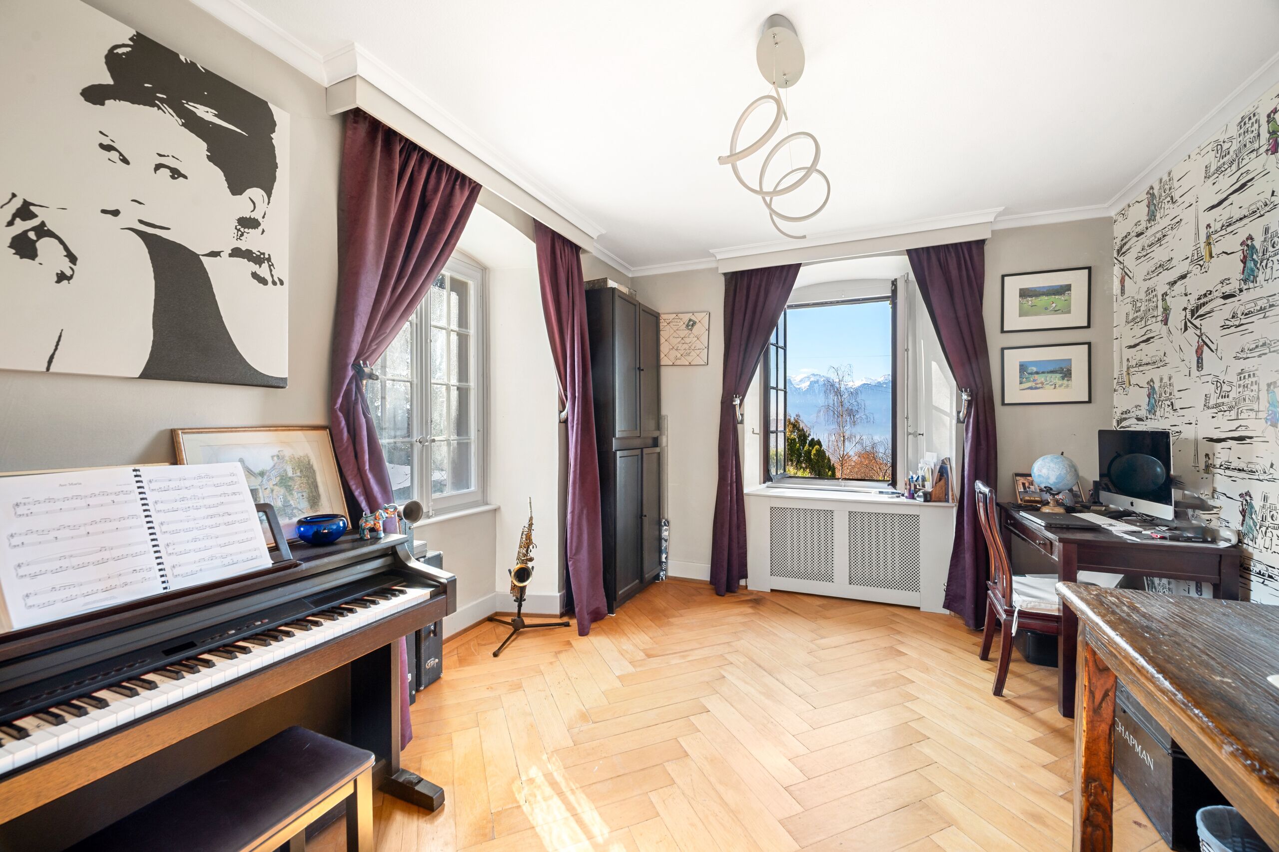 Heller Musik- und Arbeitsraum mit Blick auf die Berge