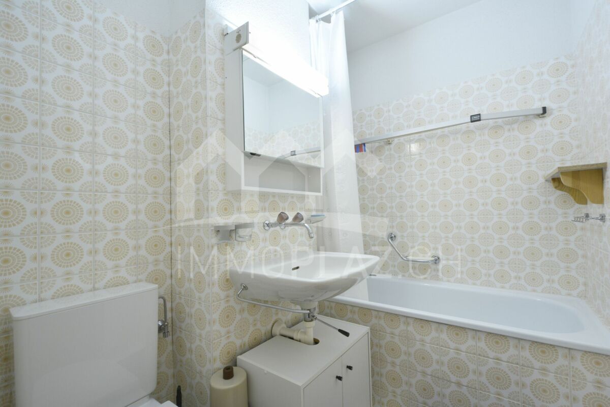 Kleines Badezimmer mit Badewanne und Waschbecken