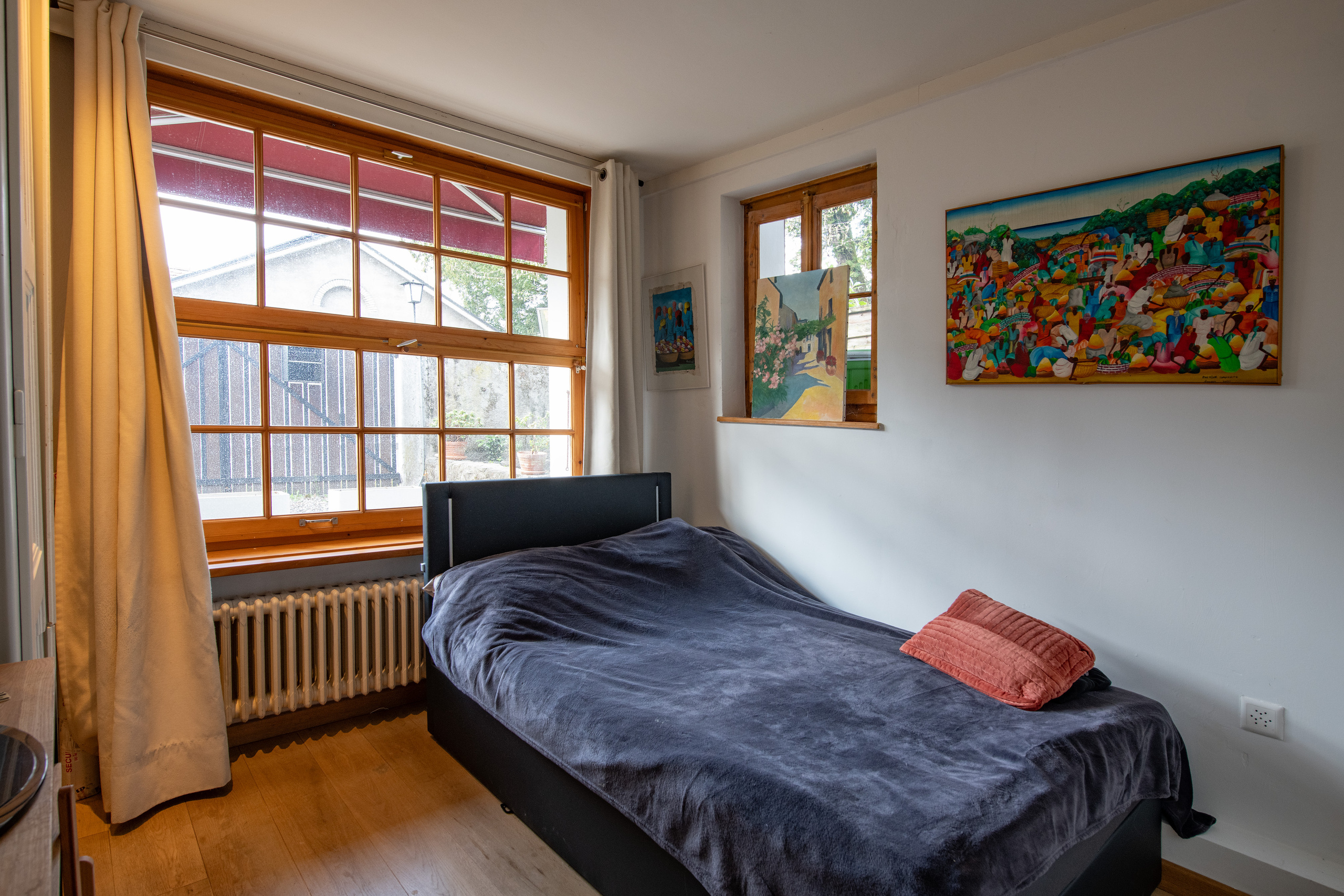 Schlafzimmer mit großem Holzfenster