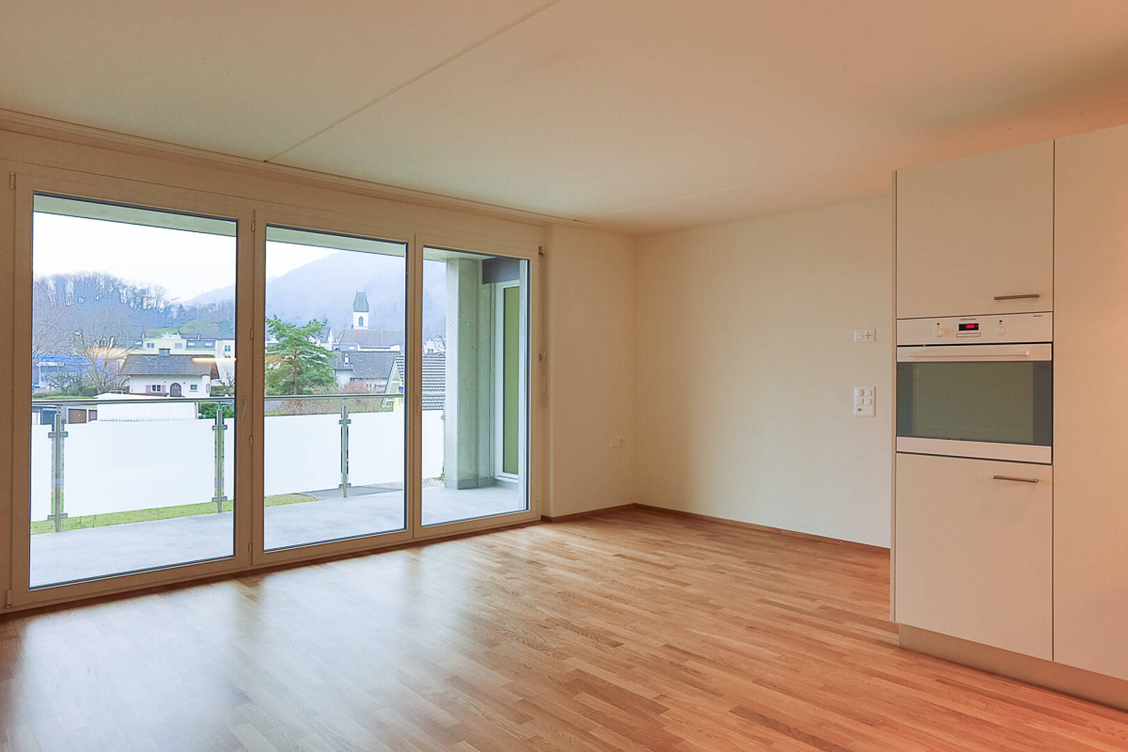 Leerer Wohnraum mit Balkonblick