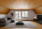 Heller Wohnraum mit Holzdecke und Schreibtisch