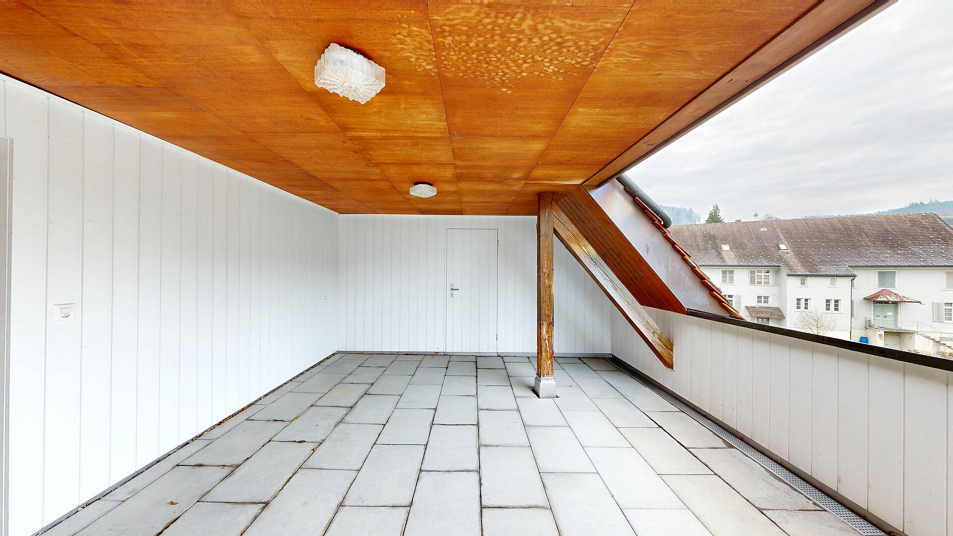 Überdachter Balkon mit Fliesenboden