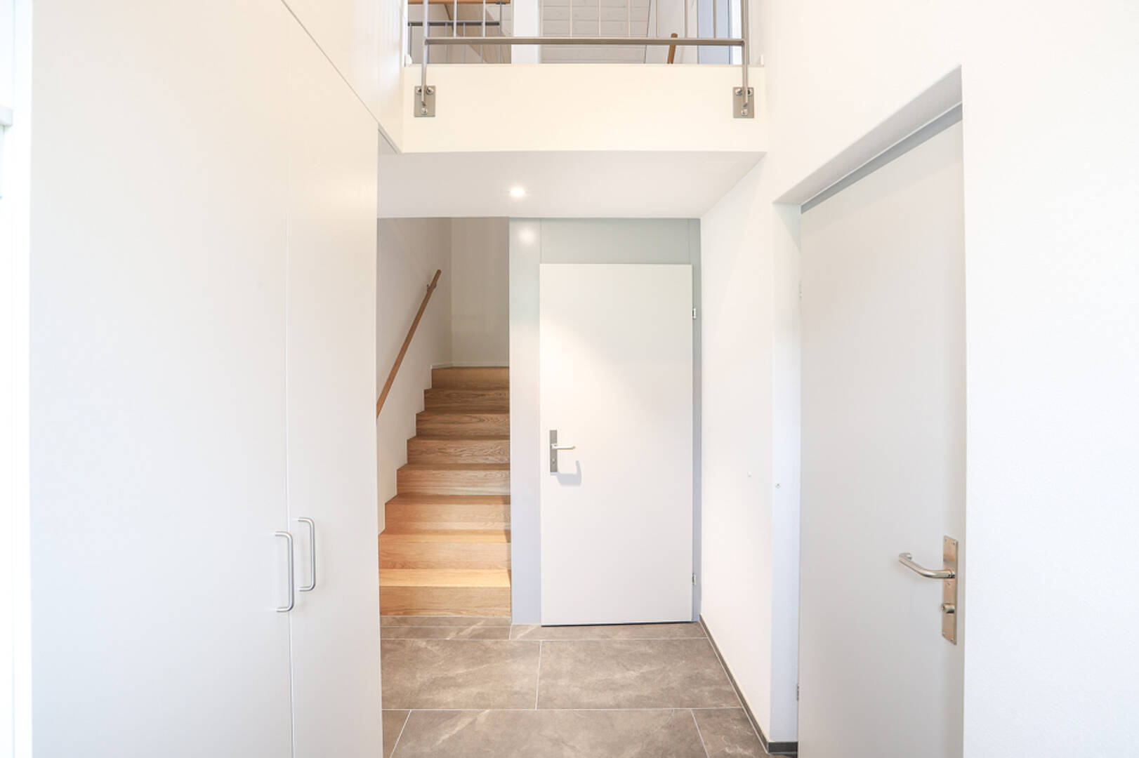 Heller Eingangsbereich mit Treppe und Stauraum