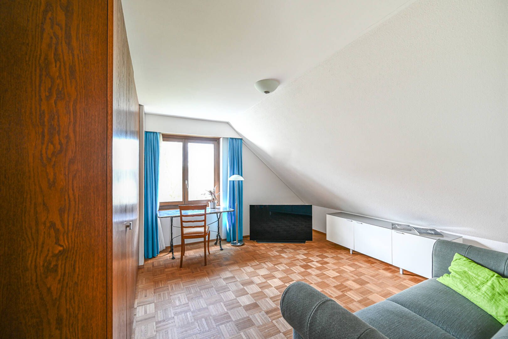 Dachzimmer mit Arbeitsplatz und Sofa