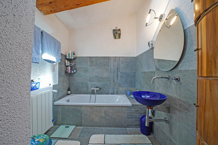 Modernes Badezimmer mit Badewanne und blauer Waschschale