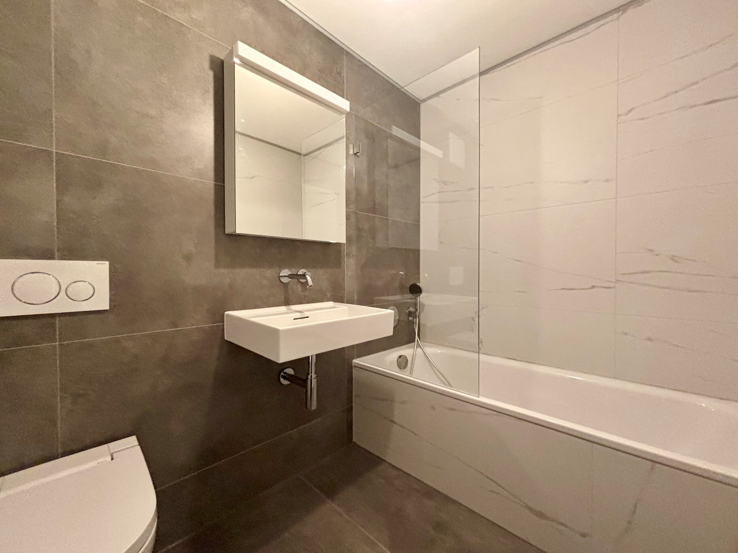 Modernes Badezimmer mit Badewanne und wandhängendem WC