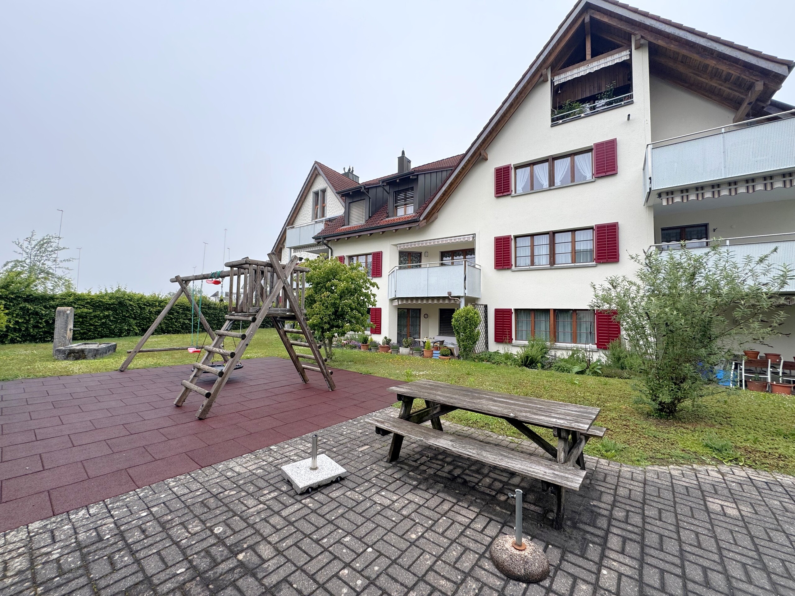 Außenansicht eines Mehrfamilienhauses mit Garten