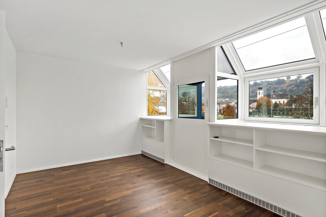 Helles Zimmer mit Dachfenstern und Blick ins Grüne