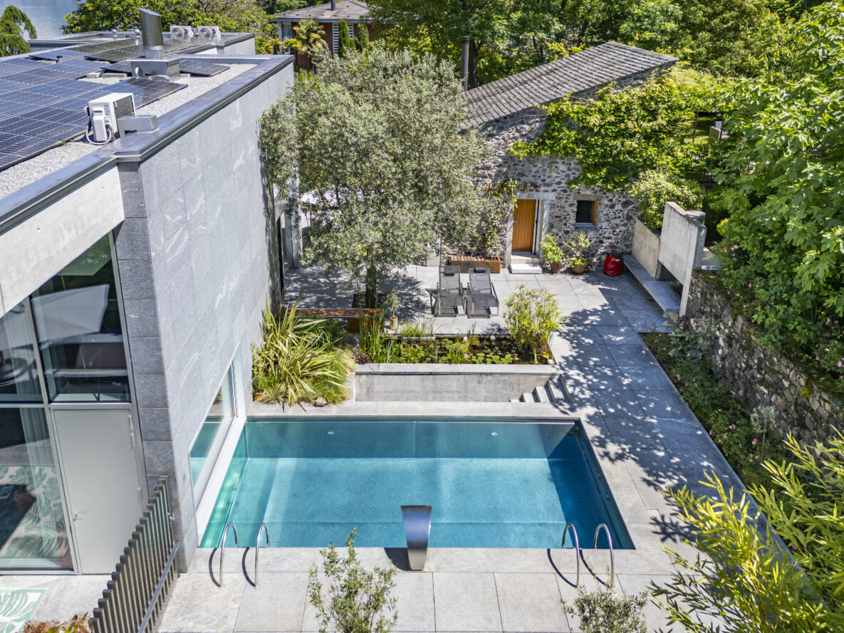 Moderner Außenbereich mit Pool und mediterranem Steinbau