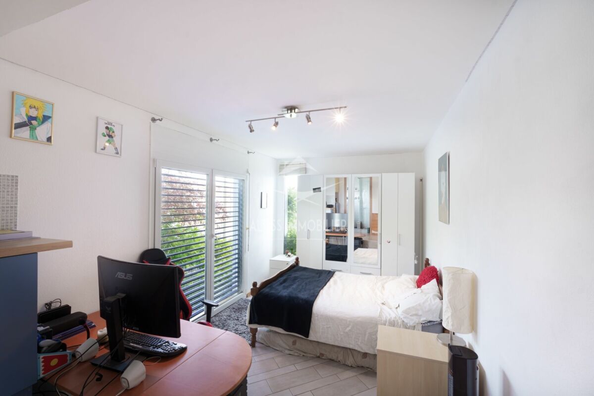 Helles Schlafzimmer mit Schreibtisch und Kleiderschrank