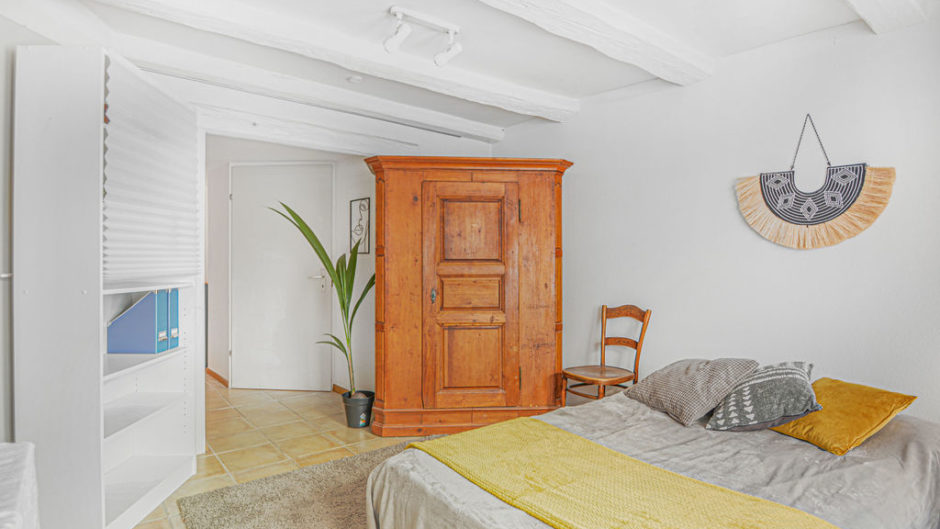 Helles Schlafzimmer mit rustikalem Schrank