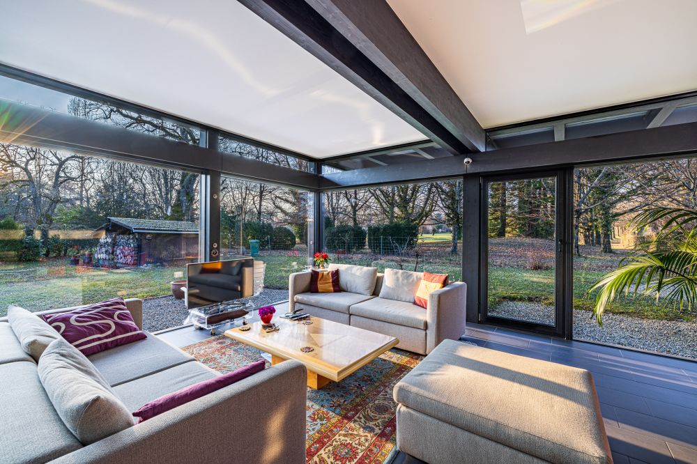 Verglaster Wohnraum mit Gartenblick