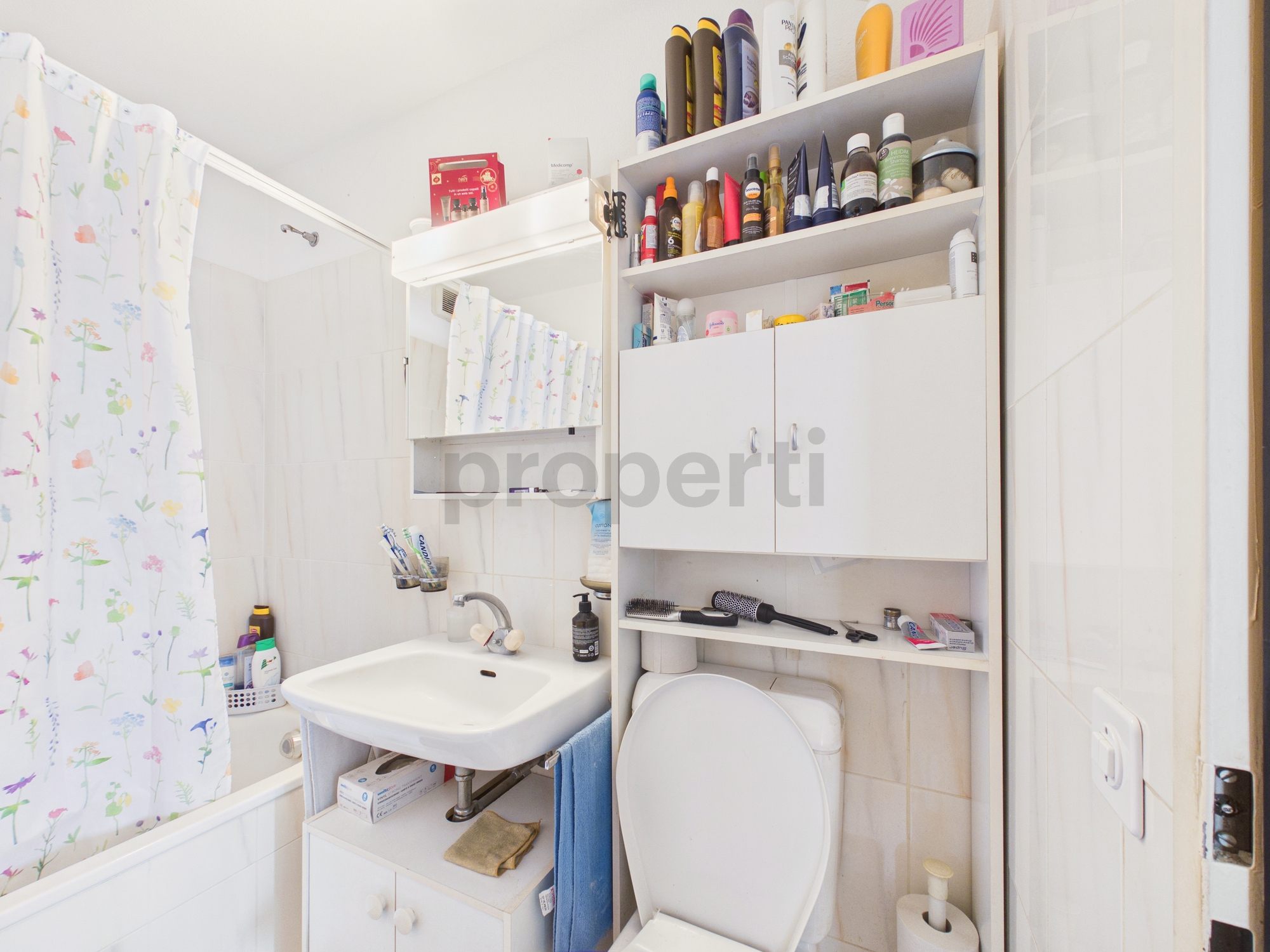 Kleines, helles Badezimmer mit Wanne, Waschbecken und WC