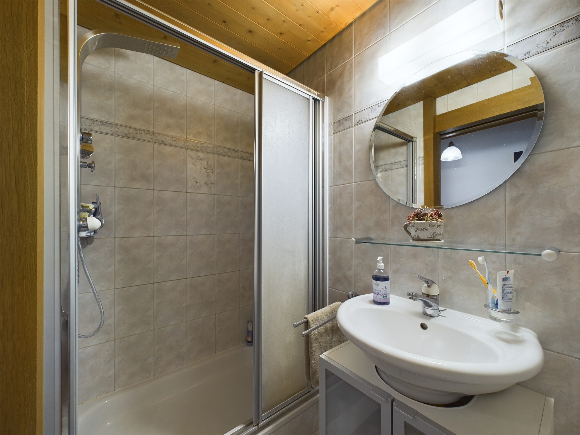 Badezimmer mit Dusche und Waschbecken