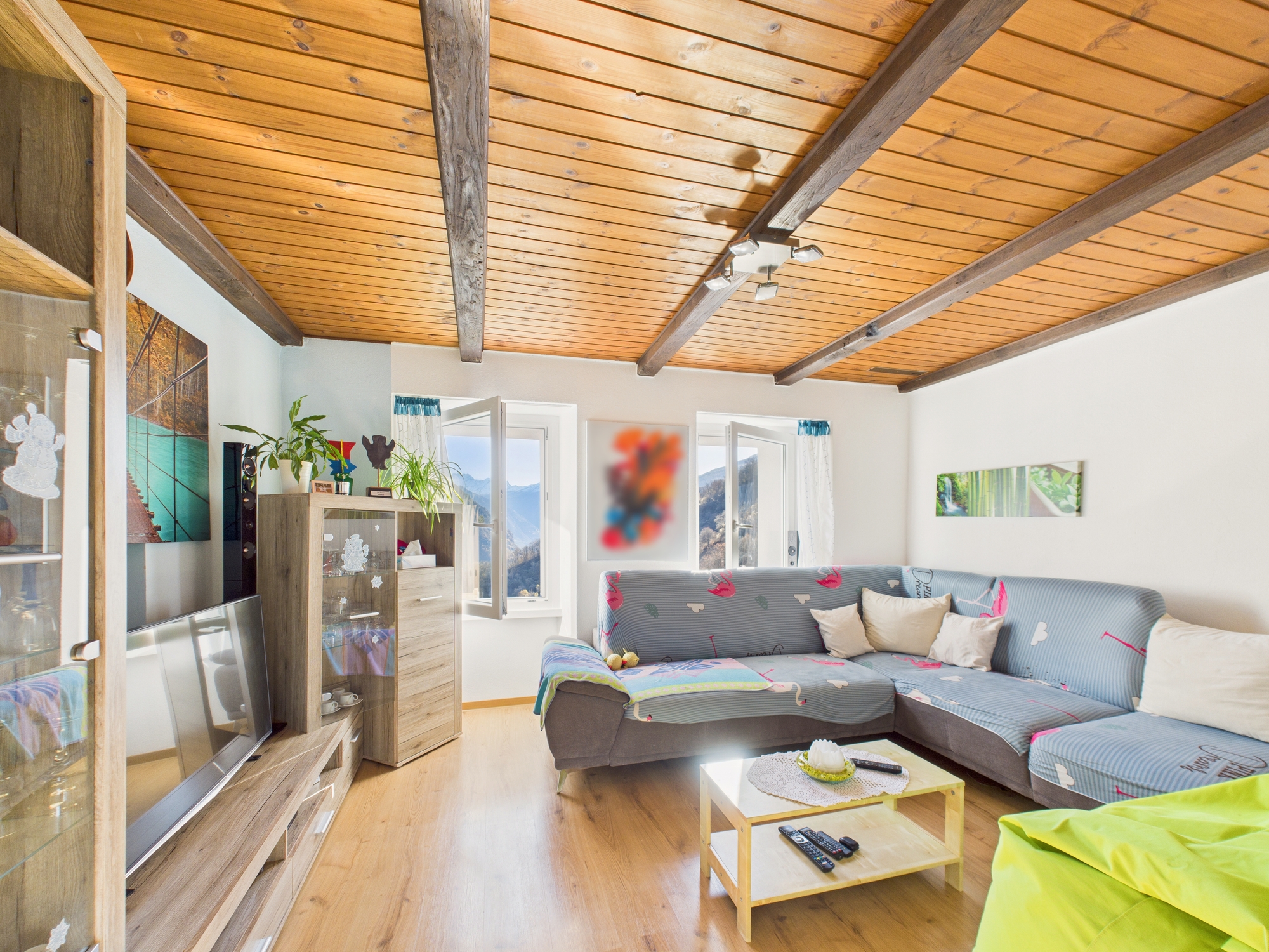 Wohnzimmer mit Holzdecke und Bergblick