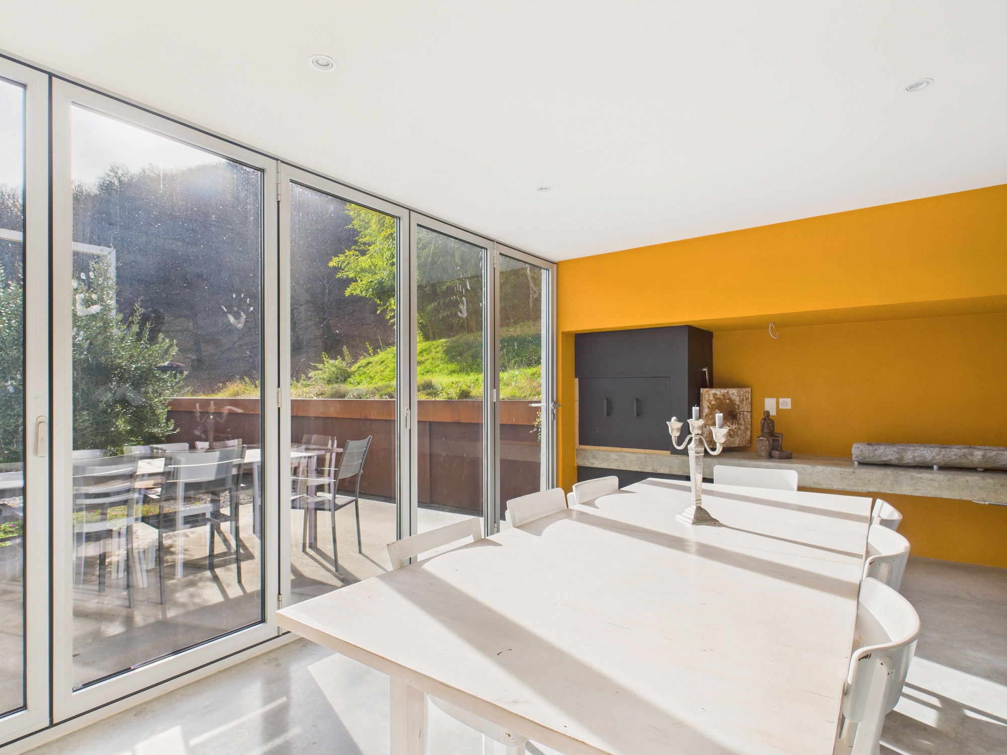 Esszimmer mit großer Fensterfront und Terrassenzugang