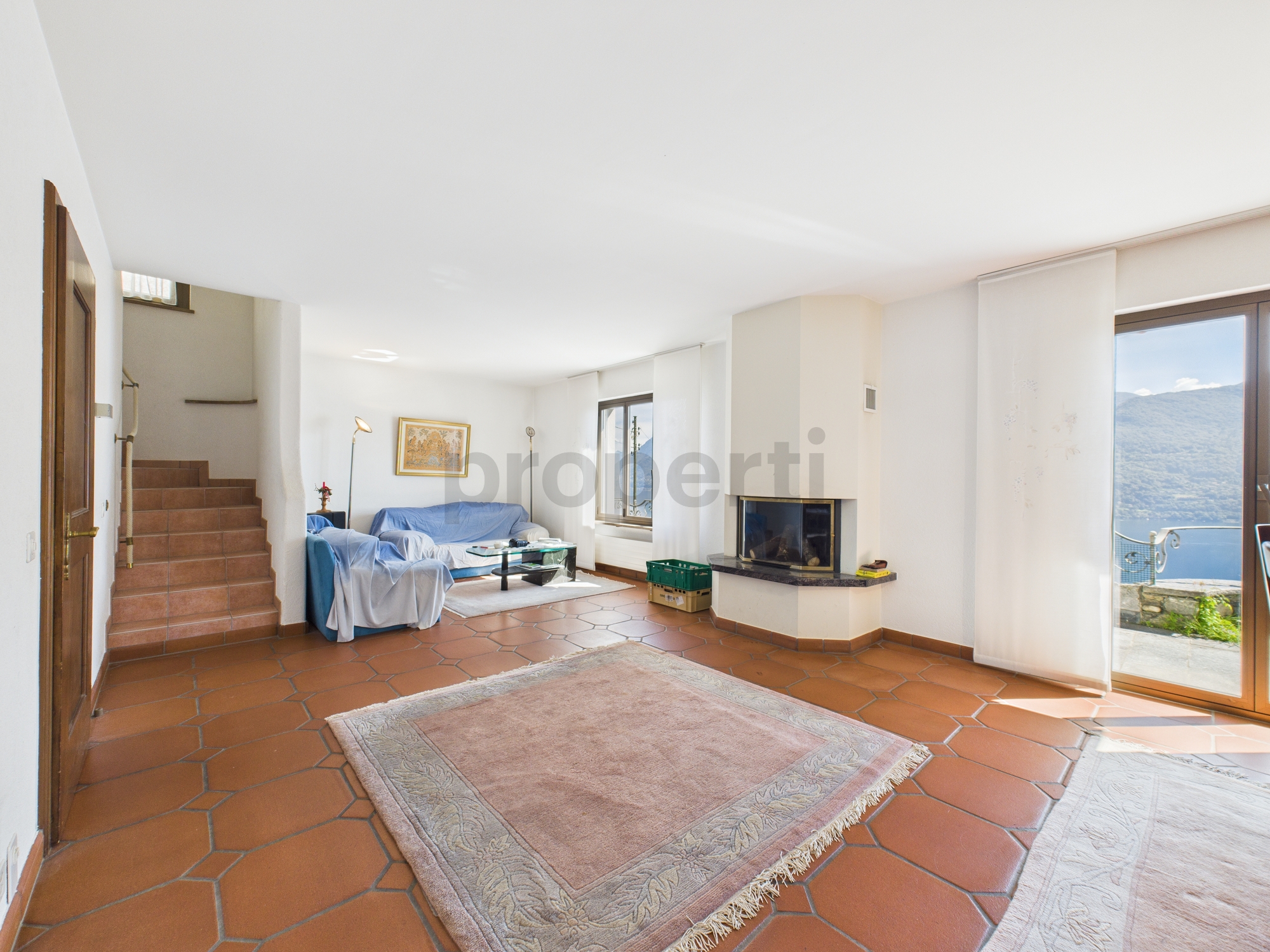 Heller Wohnraum mit Kamin und Blick ins Tal