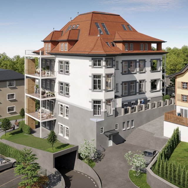 Mehrfamilienhaus mit rotem Walmdach