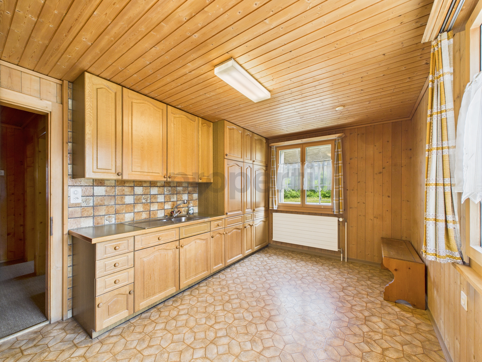 Holzverkleidete Küche mit Dachschräge