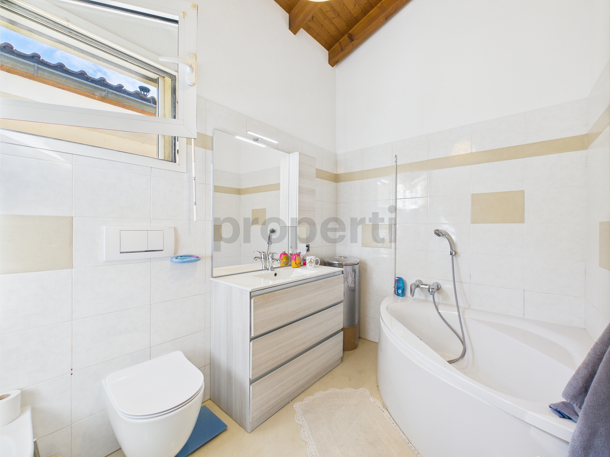 Modernes Badezimmer mit Badewanne und Dachfenster