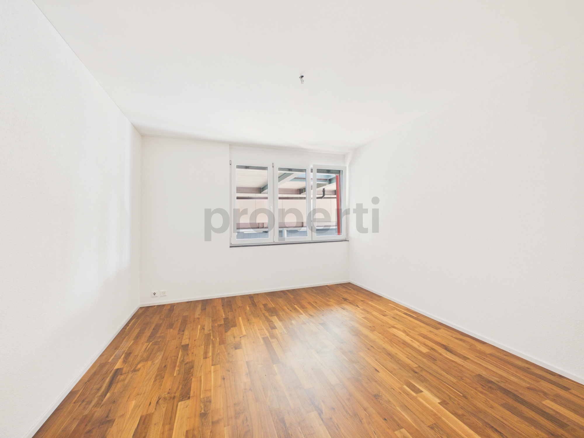 Leeres helles Zimmer mit Holzfußboden