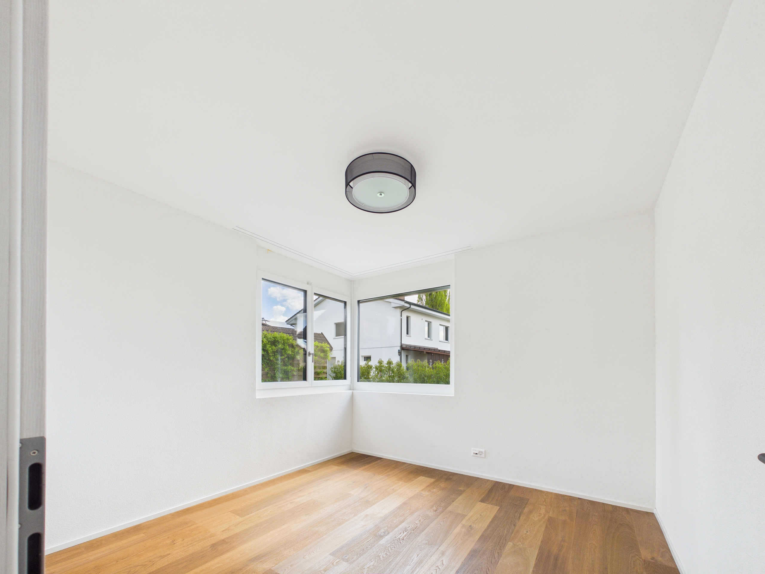 Helles, leeres Zimmer mit Fensterfront