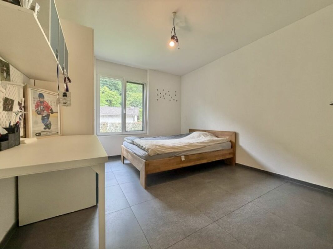 Schlichtes Schlafzimmer mit großem Fenster