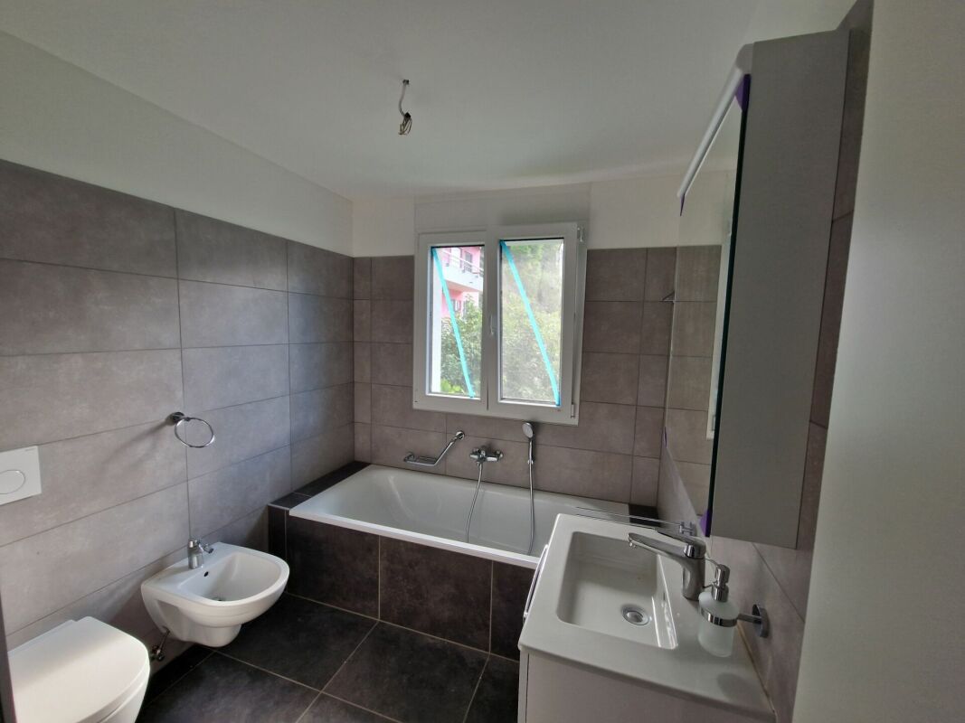 Modernes Badezimmer mit Badewanne und Fenster