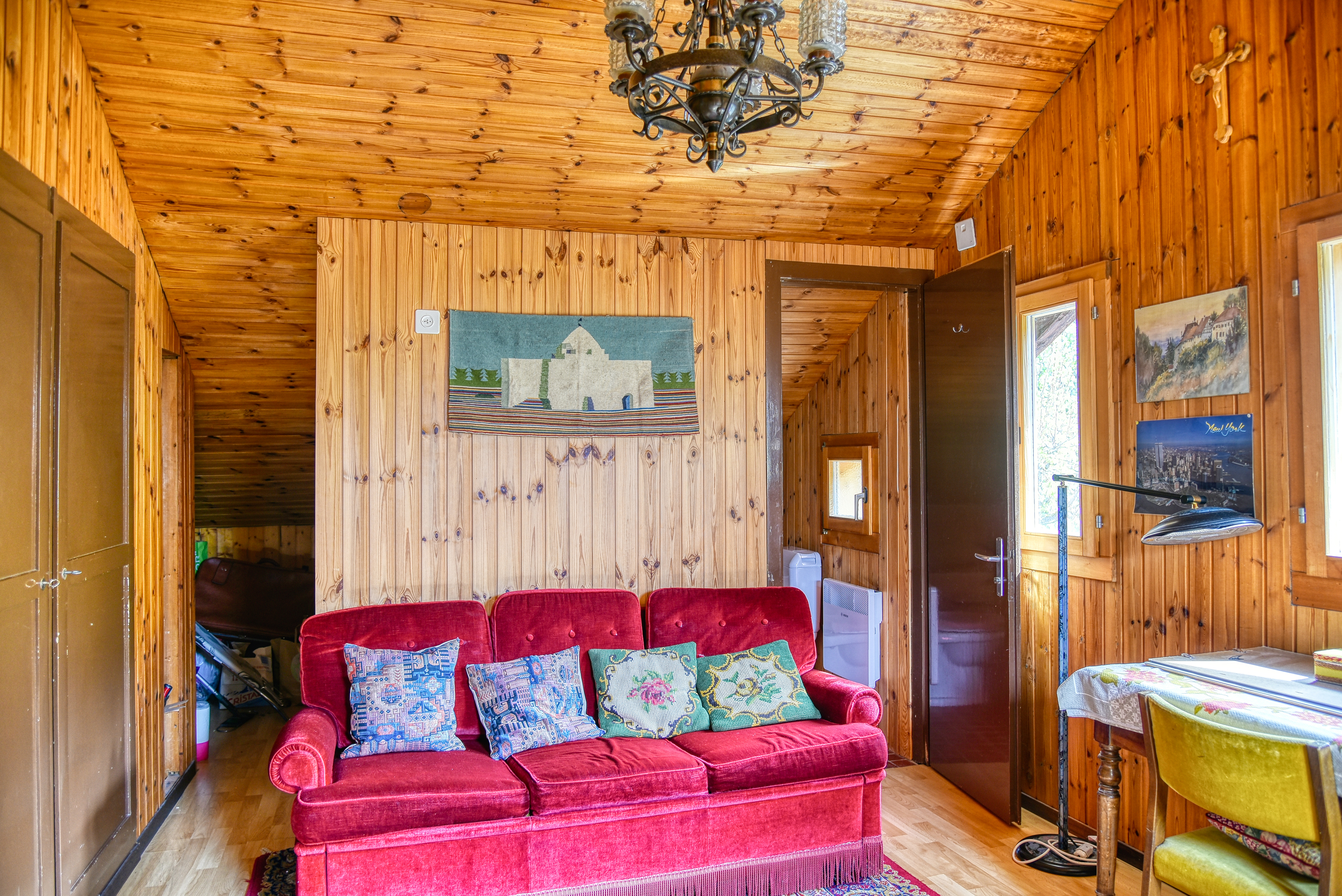 Gemütliches Holzwohnzimmer mit rotem Sofa