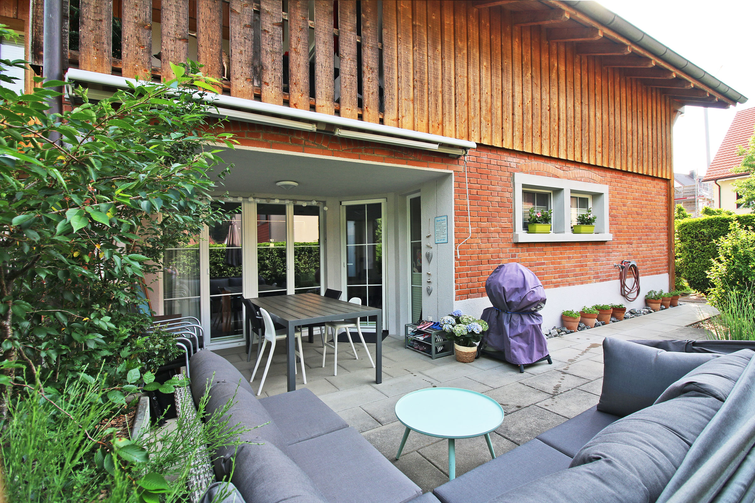 Terrasse mit Holzfassade und Sitzgruppe
