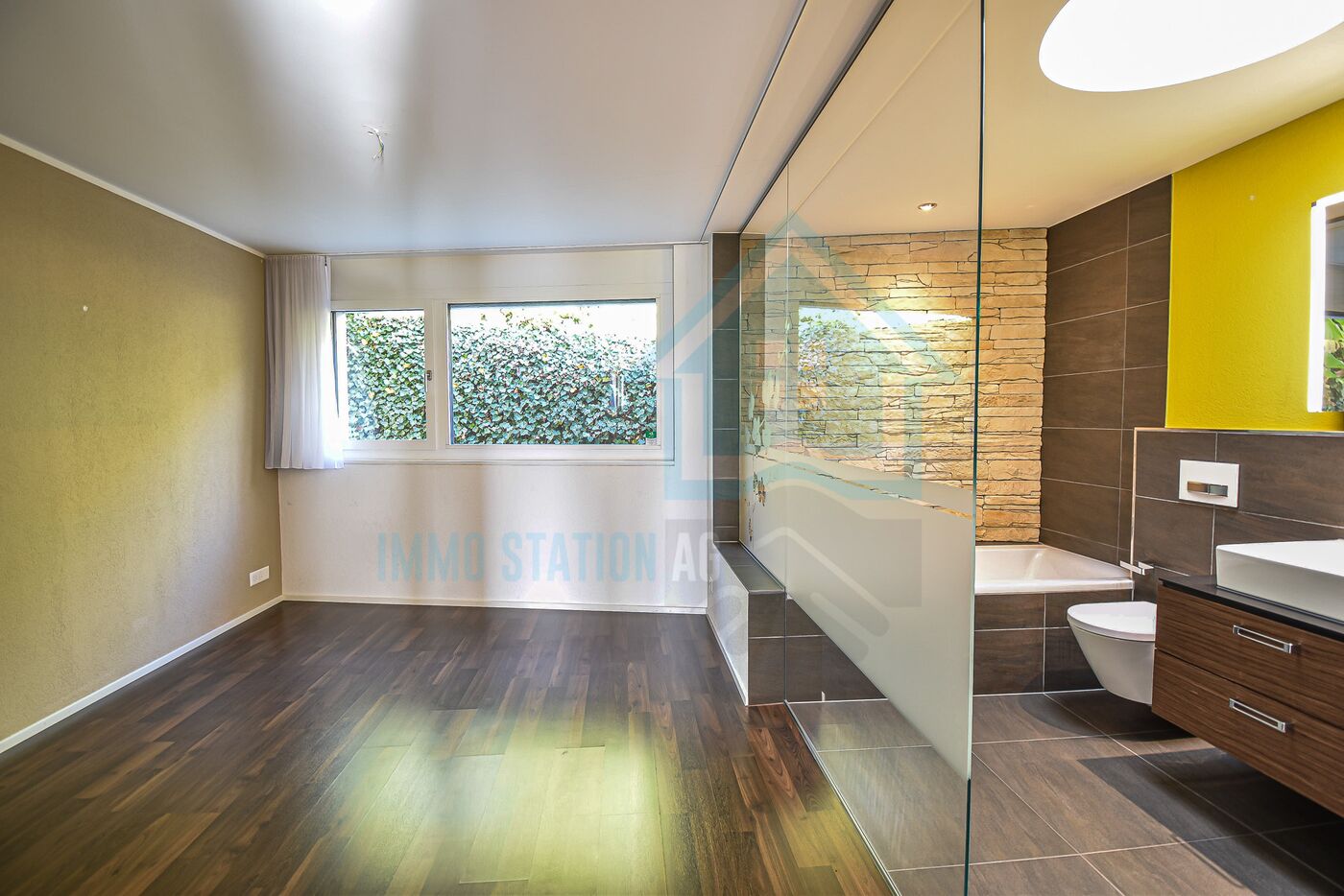 Modernes Badezimmer mit angrenzendem Schlafbereich