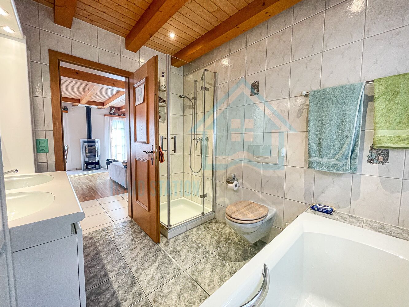 Badezimmer mit Dusche, Wanne und Holzdecke