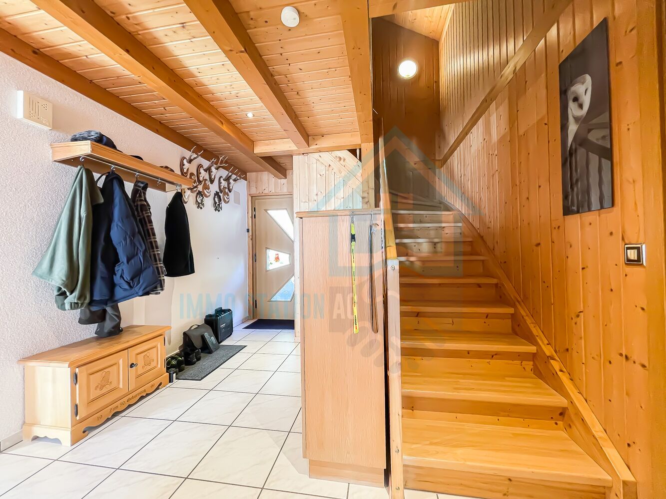Heller Eingangsbereich mit Holztreppe