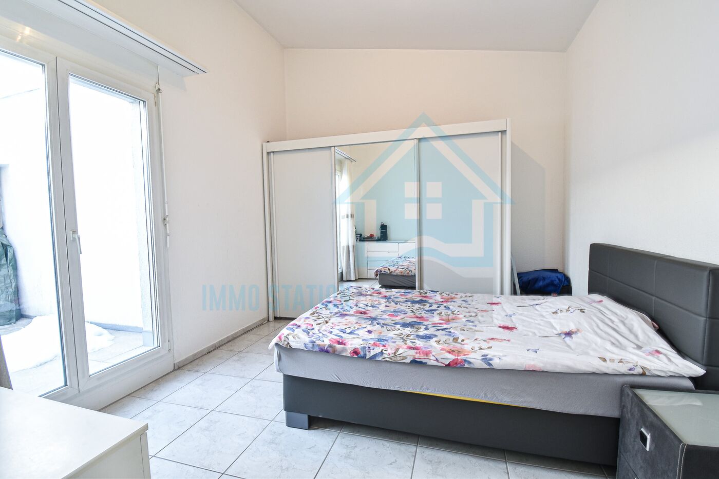 Helles Schlafzimmer mit Balkonzugang und Kleiderschrank