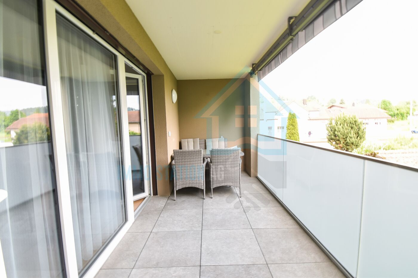 Überdachter Balkon mit Sitzgruppe
