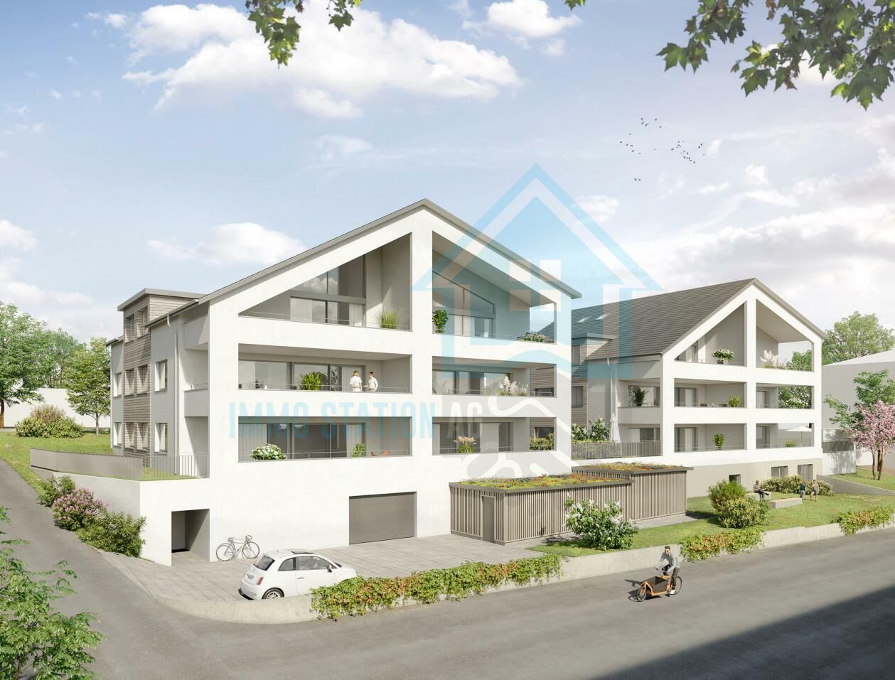 Moderner Wohnkomplex mit Dachgauben und Grünflächen