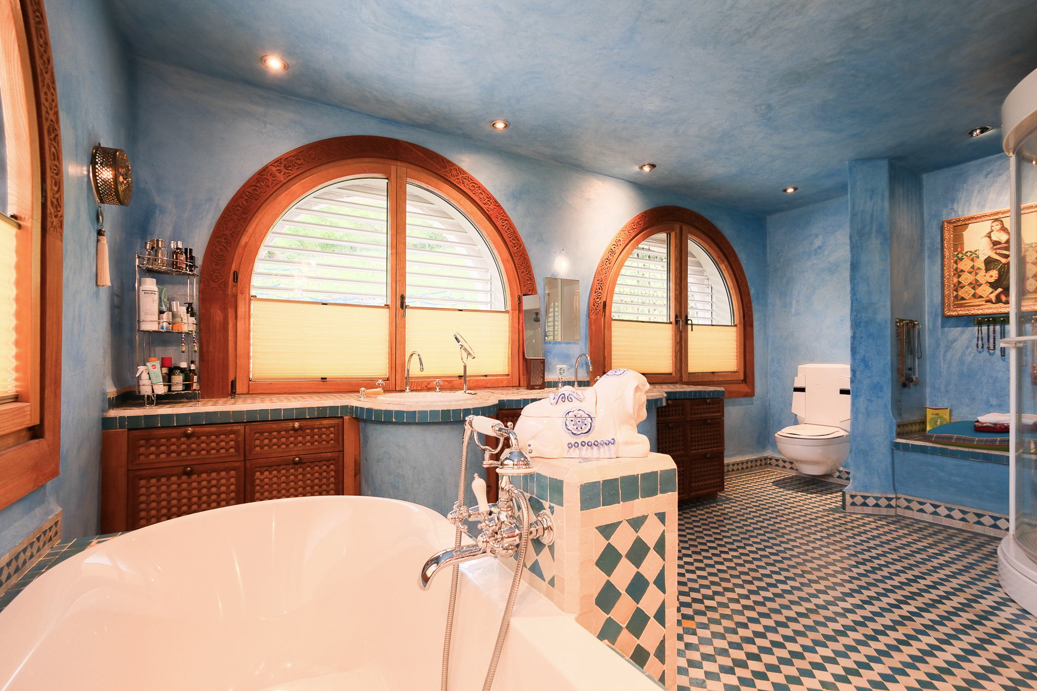 Verspieltes Badezimmer mit blau verputzten Wänden und mediterranen Details