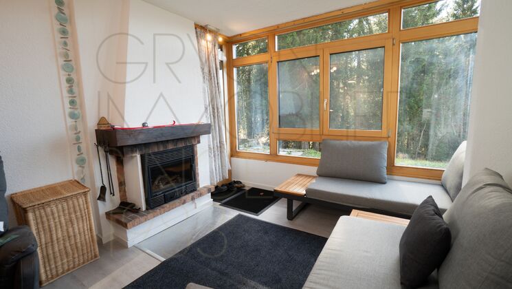 Wohnzimmer mit Kamin und großem Fensterband