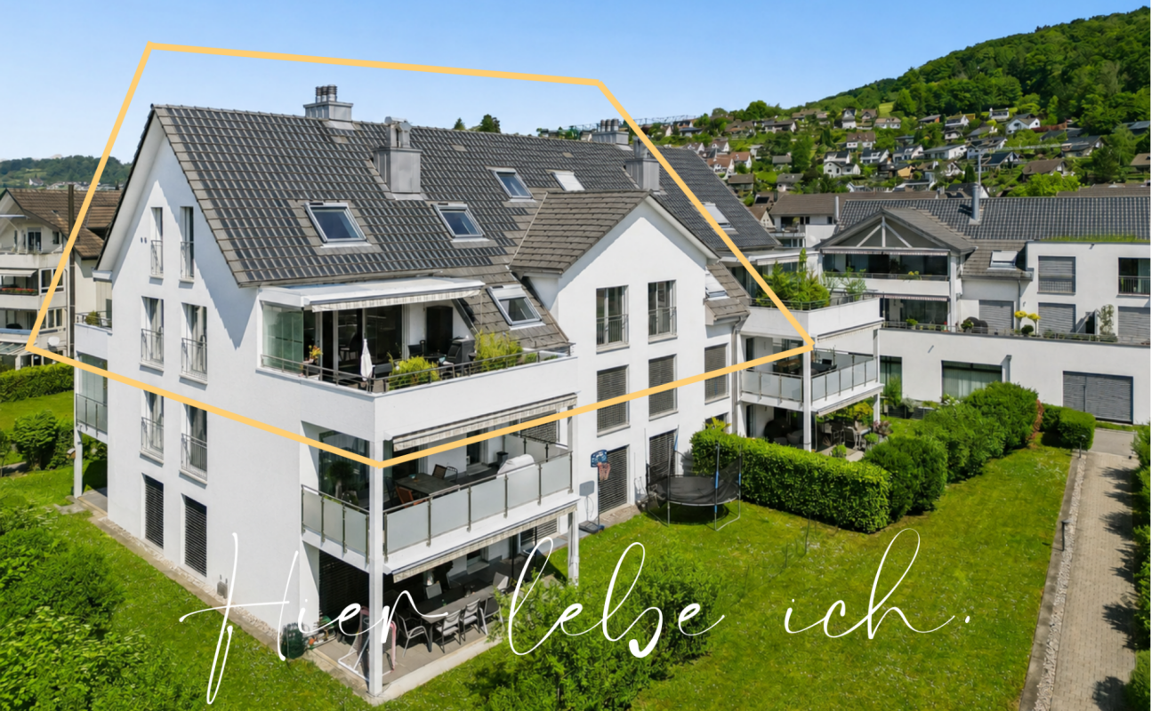 Mehrfamilienhaus mit Balkonen in grüner Hanglage