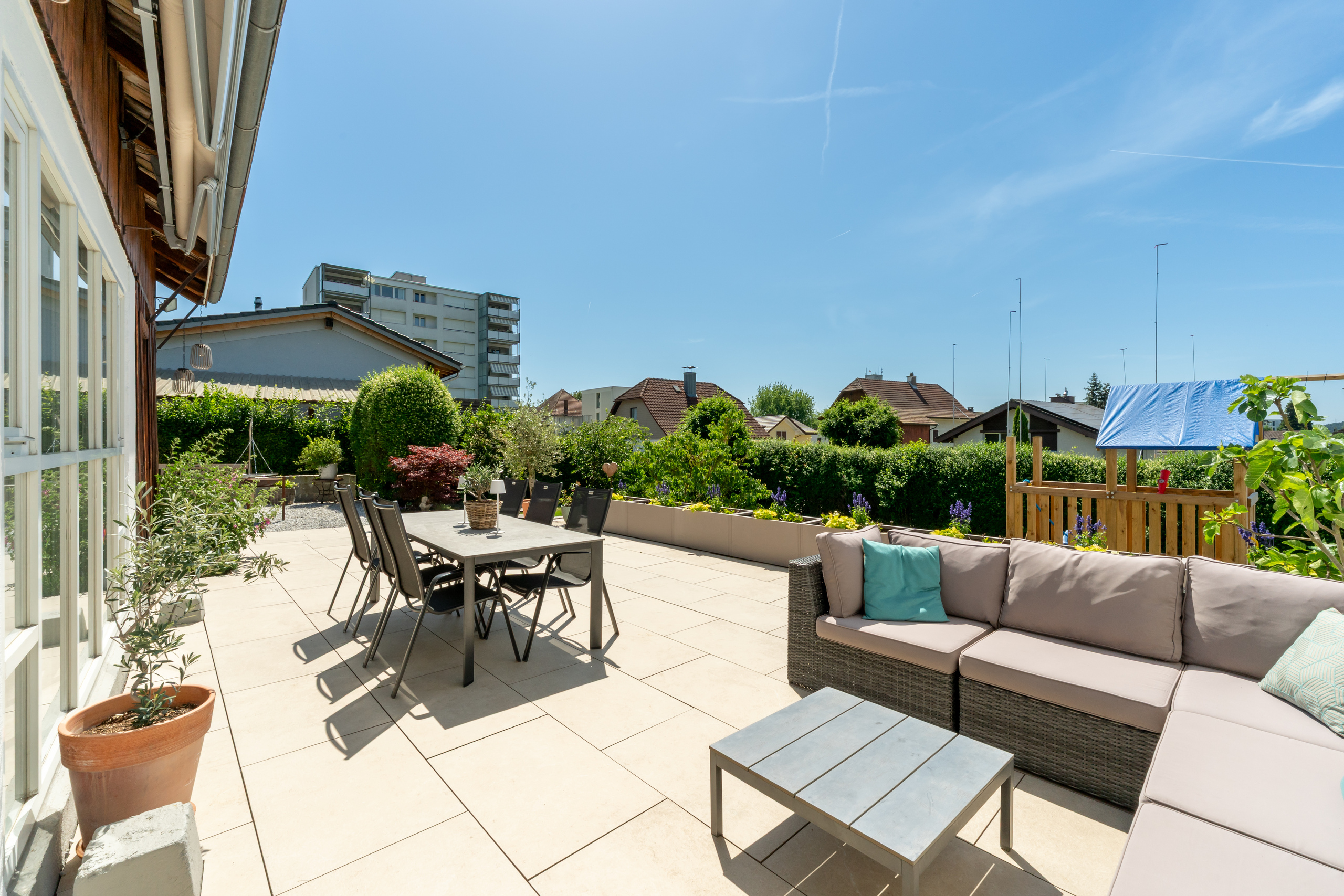 Große sonnige Terrasse mit Gartenblick