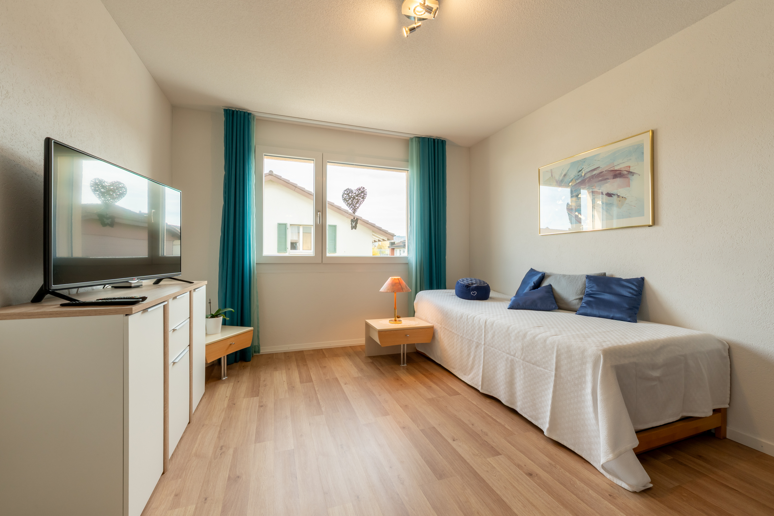 Helles Schlafzimmer mit Einzelbett und Fenster