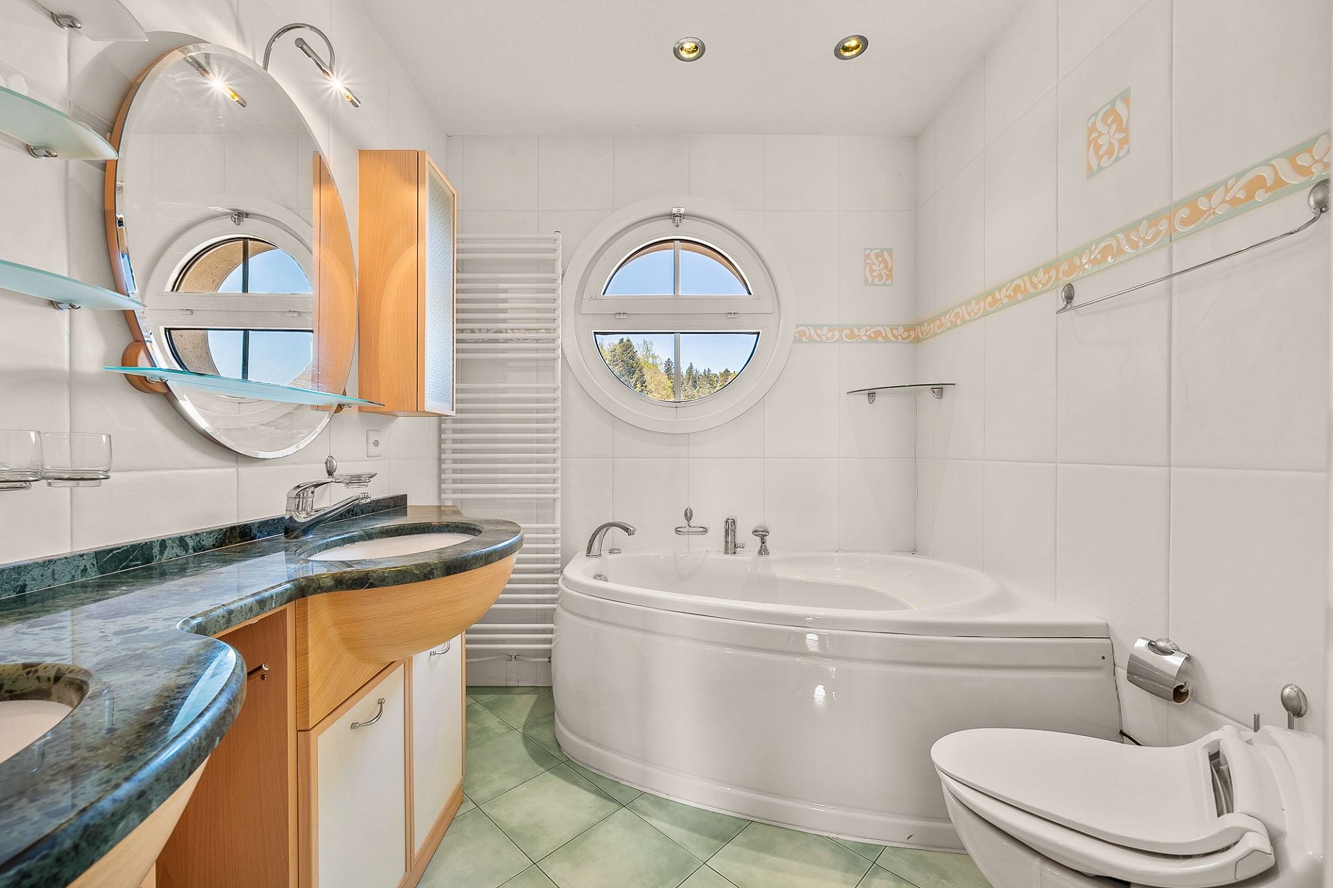 Luxuriöses Badezimmer mit Rundfenstern und Badewanne