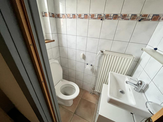 Kleines Gäste-WC mit Waschbecken und Heizkörper