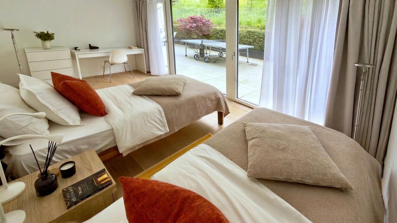 Helles Schlafzimmer mit zwei Einzelbetten und Terrassenzugang
